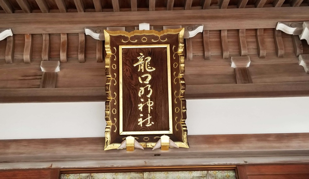 龍口明神社の扁額　縦に文字が書かれている